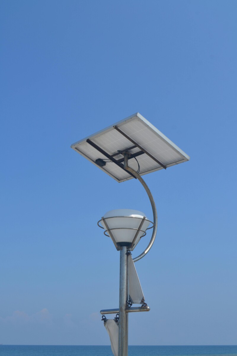 pexels photo 14422550 14422550 Solar-powered street lamp against a clear blue sky in Jakarta, showcasing renewable energy solutions.