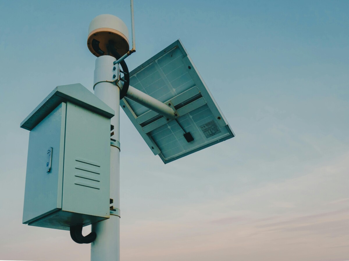pexels photo 30228097 30228097 A solar panel paired with a security camera against a clear sky, representing renewable technology.