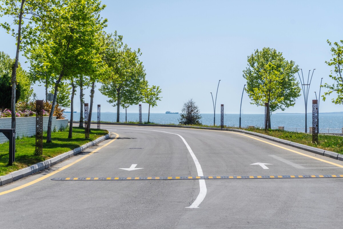 pexels photo 33971095 33971095 A curved road by the sea in Baku, Azerbaijan, lined with trees and clear blue skies, offering a peaceful scene.